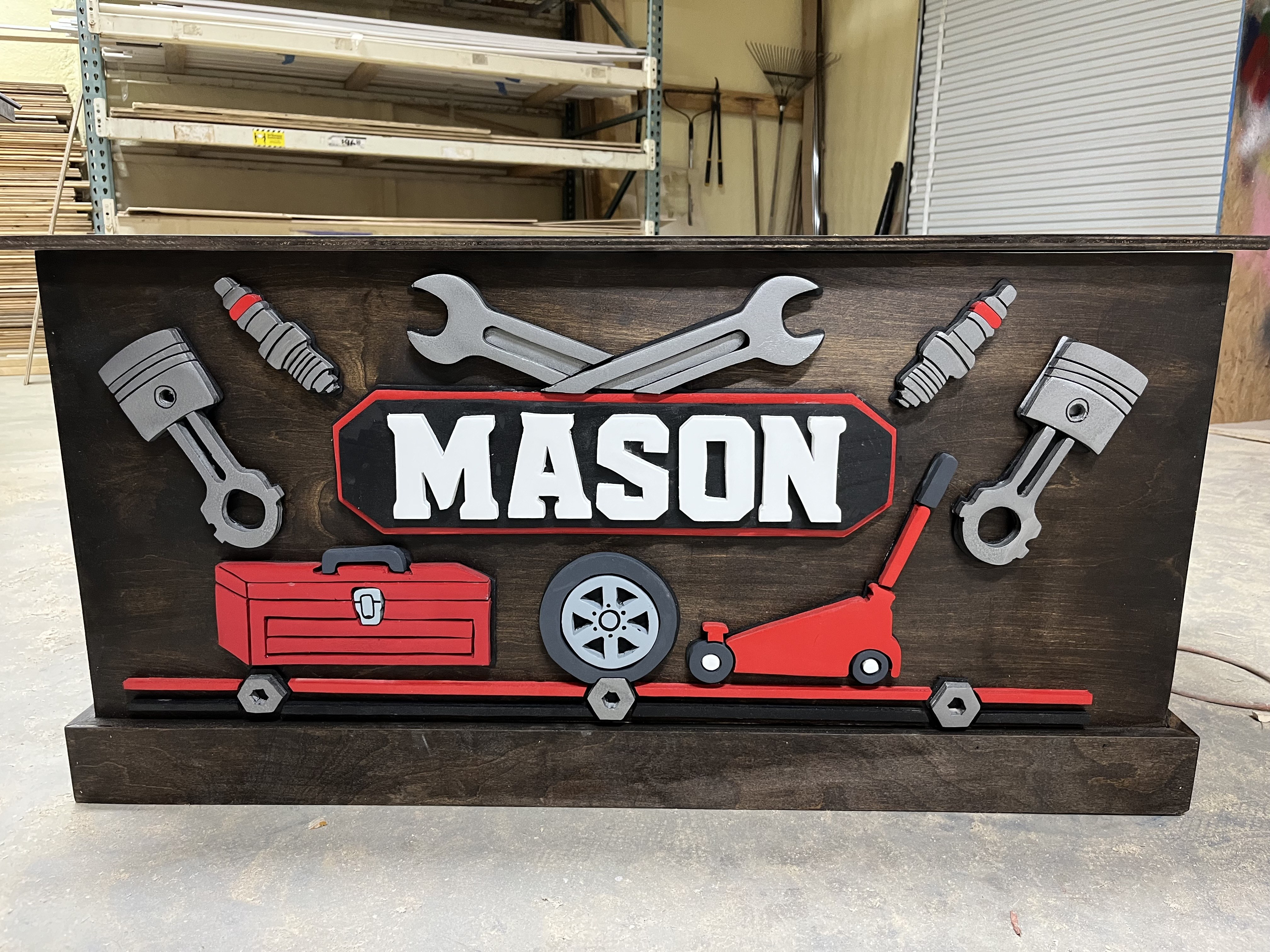Mechanic toy box for Mason, pistons, wrenches and a tool box all cut and raised off the front.