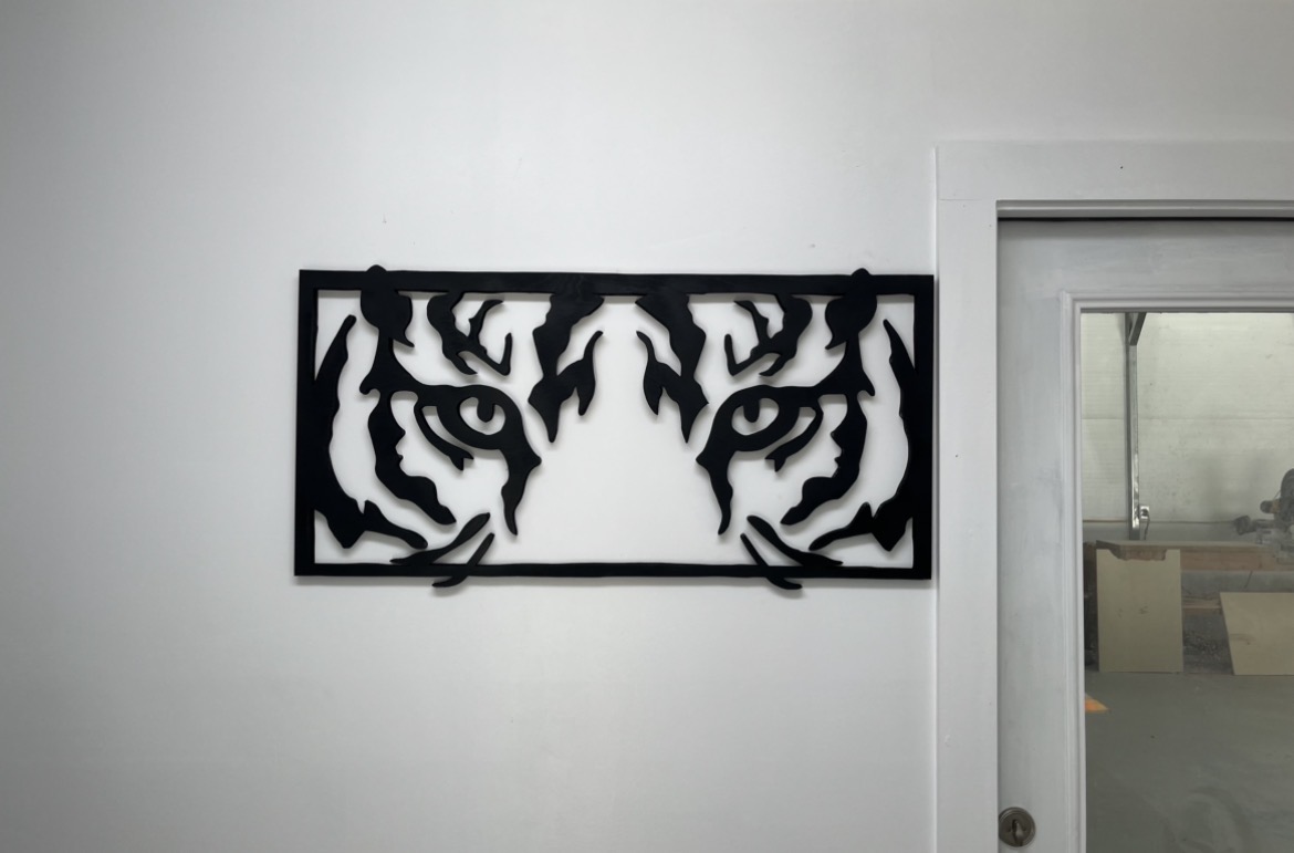 Tiger eyes wall panel in flat black, every line cut on the jigsaw