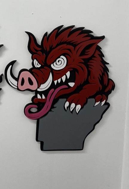 Razorback busting out of the Arkansas state shape, cut and layered by hand