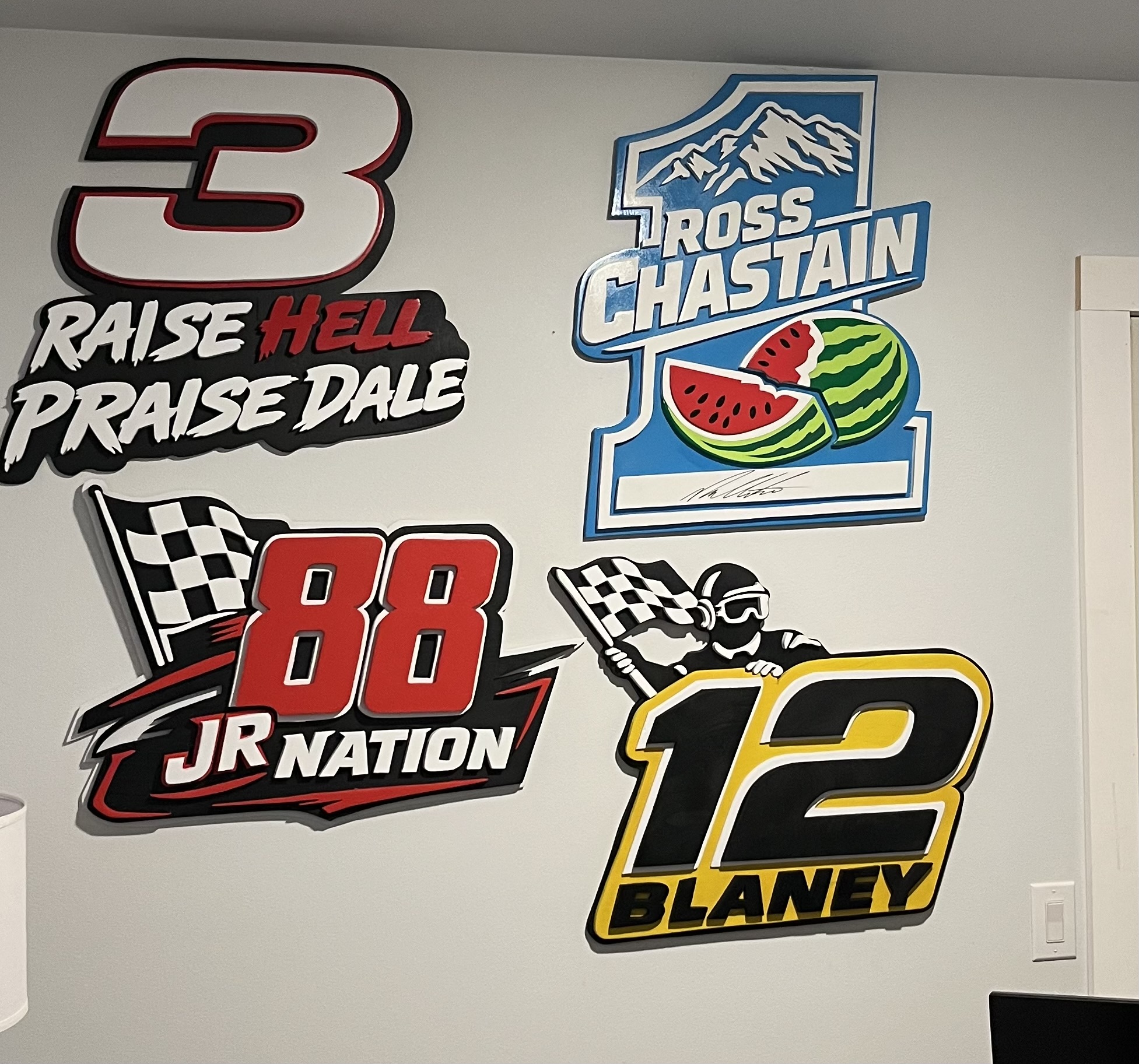 Driver number wall, #3, #88, #12 and the Chastain #1, all hand-cut and layered