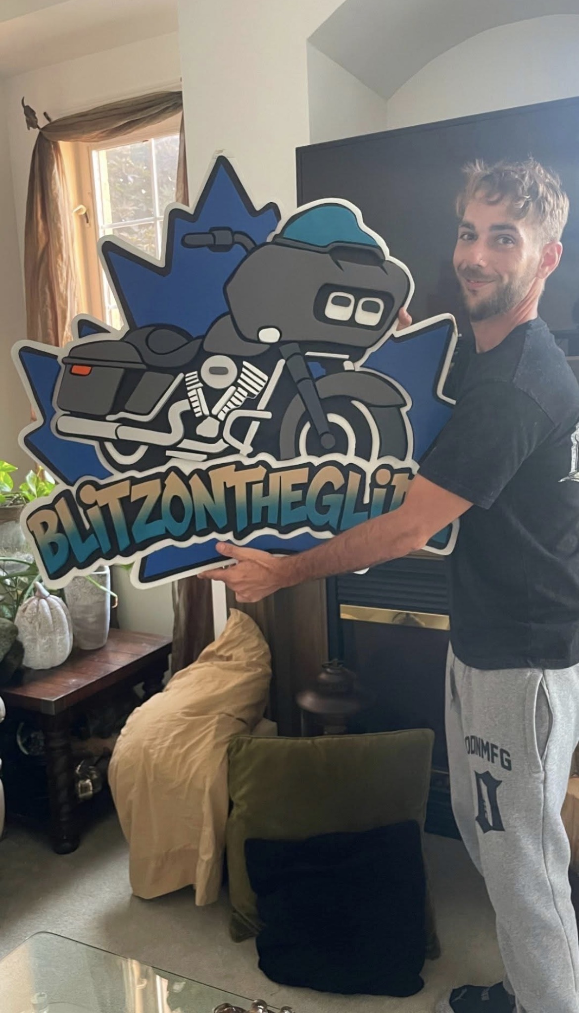 Custom motorcycle club sign with a cartoon rider and hand-cut club lettering